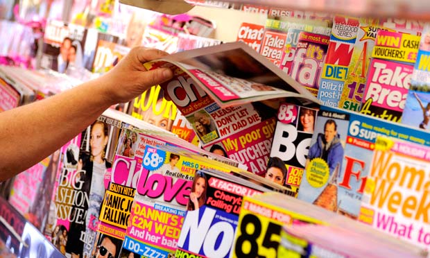 Magazines on a stand in a newsagents.