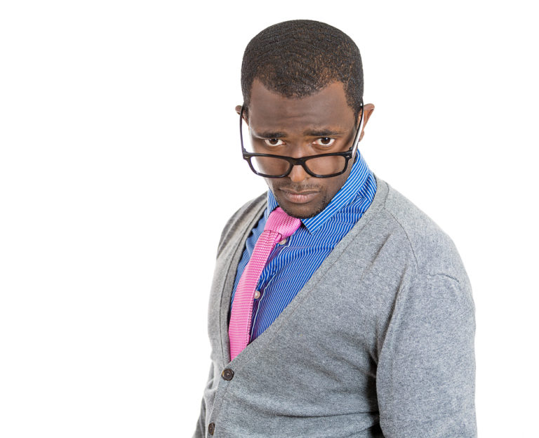 shutterstock Closeup portrait of handsome cocky guy with big black glasses looking at you camera gesture skeptically, isolated on white background. Negative human emotion facial expression feeling, body language swagger