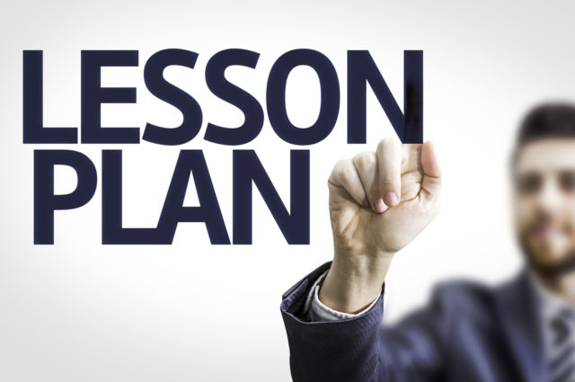 shutterstock Business man pointing to transparent board with text: Lesson Plan Learning Policy
