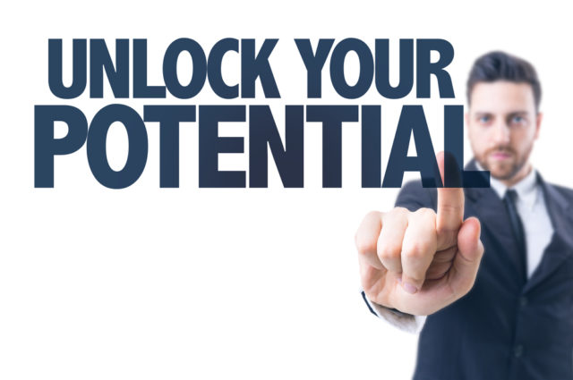 shutterstock_271790072 Business man pointing the text: Unlock Your Potential Leadership Interview Man Suit Beard