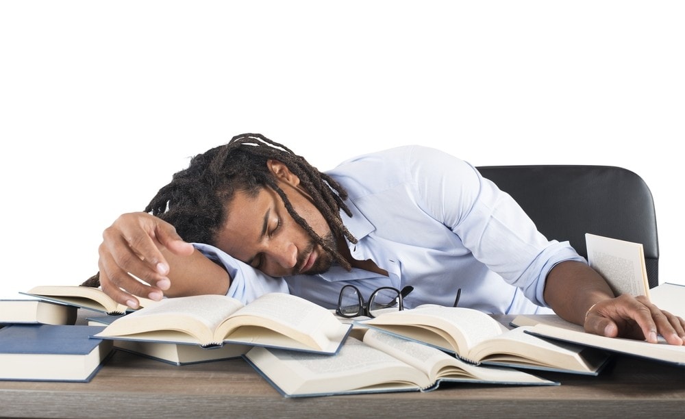 Shutterstock 296244977 Tired Teacher Falls Asleep While Reading Books