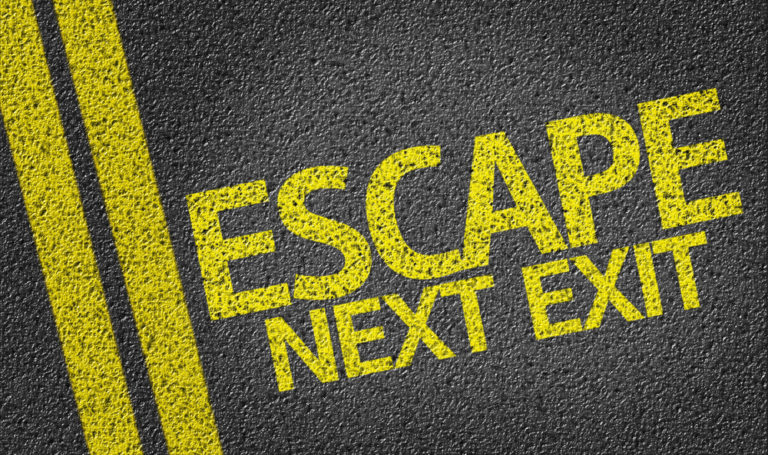 shutterstock_201765647 Escape, Next Exit written on the road