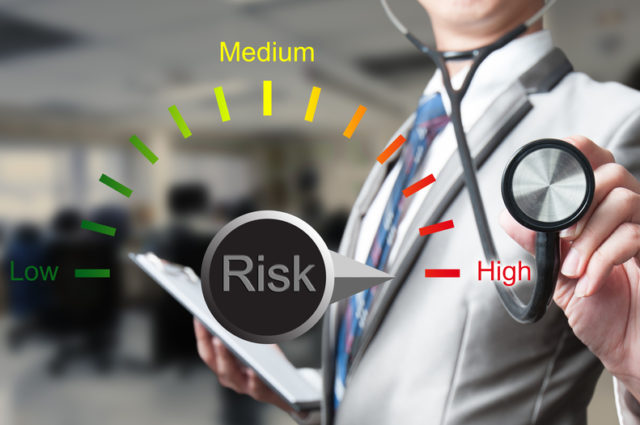 shutterstock_259207889 businessman with stethoscope working on risk management, business concept