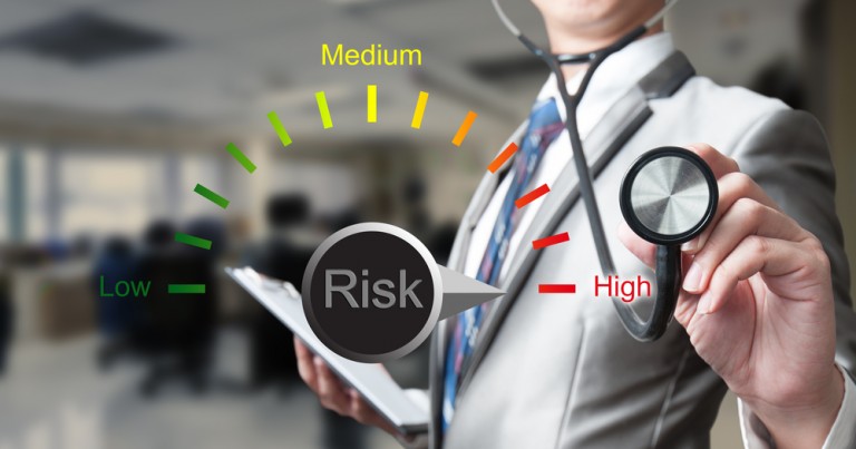 shutterstock_259207889 businessman with stethoscope working on risk management, business concept