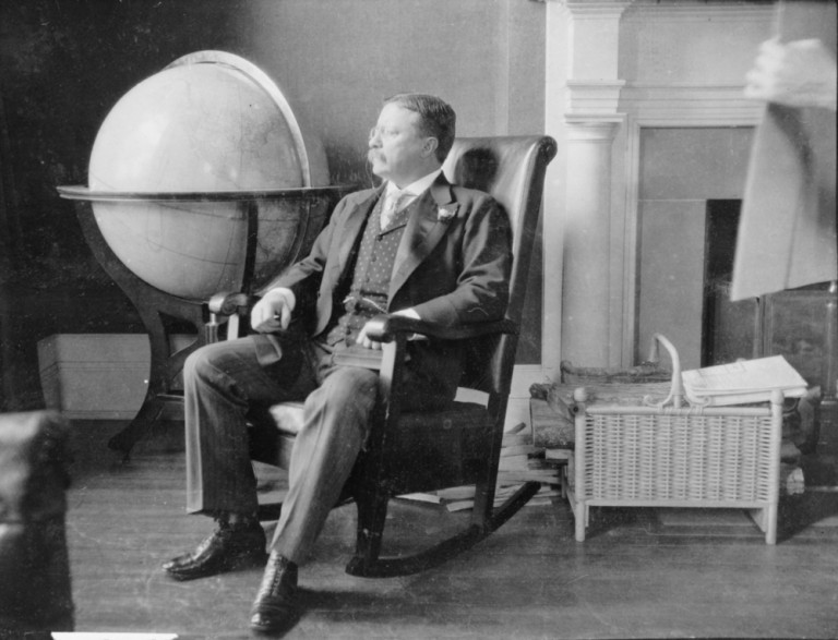 shutterstock_239398987 Theodore Roosevelt, at the end of his presidency, seated in rocking chair, by large globe. During Roosevelt's presidency, the United States was recognized as a world power.