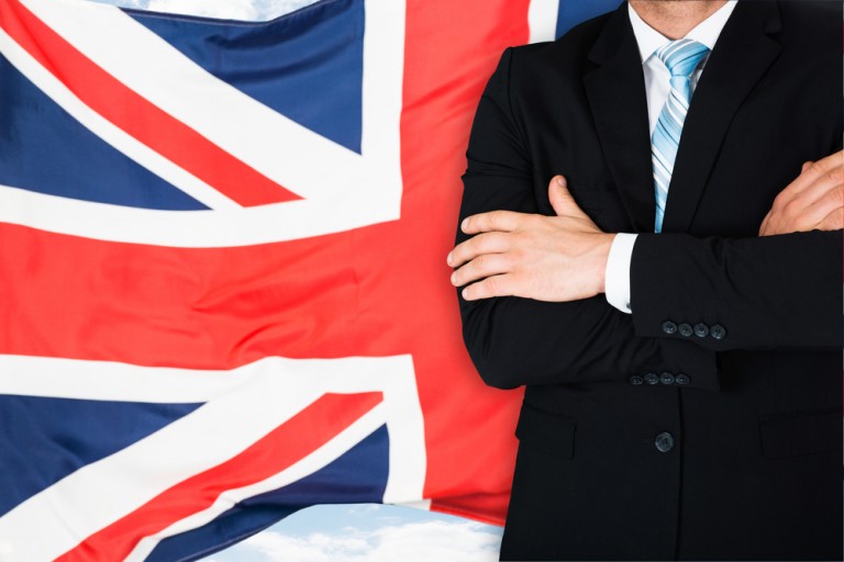 shutterstock_252583750 Close-up Of Businessman In Front Of British Flag