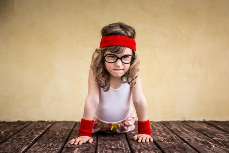shutterstock_309774551 Funny strong child. Girl power and feminism concept