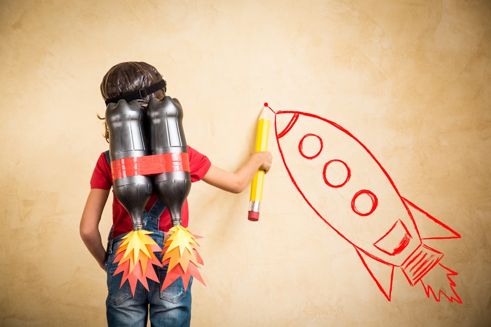 shutterstock_324288155 Kid with jet pack draw sketch on wall. Child playing at home. Success, leader and winner concept