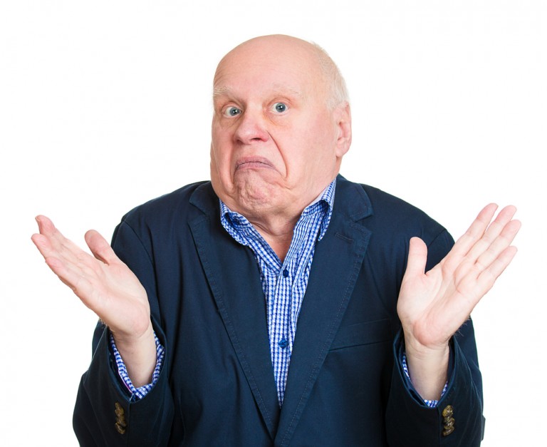 shutterstock_188182985 Closeup portrait, dumb clueless senior mature man, arms out asking why whats the problem who cares so what, I dont know. Isolated white background. Negative human emotion facial expression feelings