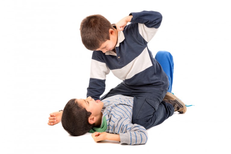 shutterstock_268614719 Young boys fighting isolated in white