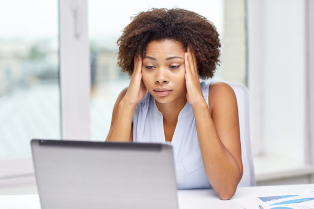 shutterstock_302658023 people, emotions, stress and health care concept - unhappy african american young woman touching her head and suffering from headache