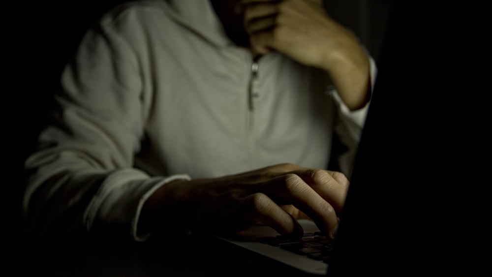shutterstock_169147106 Anonymous male on a laptop at night. Concept of internet addiction