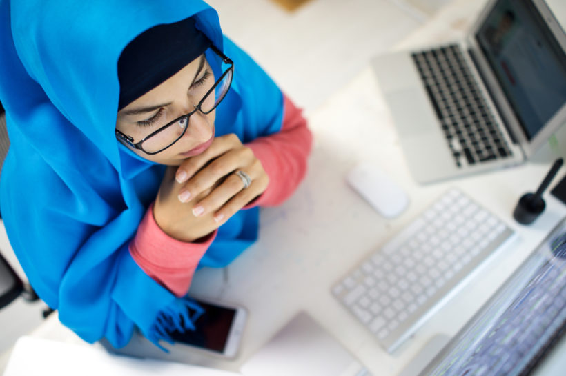 shutterstock_370832639 Attractive Muslim young woman working in office on computer