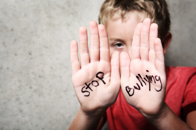 shutterstock_108383702 Stop Bullying child hands