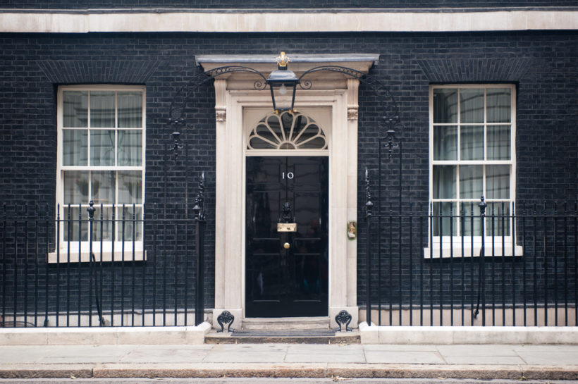 shutterstock_145853606 LONDON - JUN 16: Entrance door of 10 Downing Street in London on June 16, 2013. The street was built in the 1680s by Sir George Downing and is now the residence of the Prime Minister.