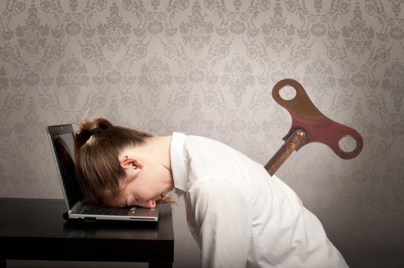 shutterstock_177516356 businesswoman with a key winder on her back sleeping on laptop