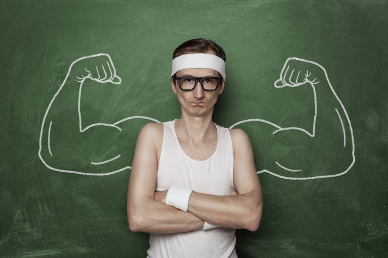 shutterstock_233563201 Funny sport nerd with huge, fake, muscle arms drawn on the chalkboard
