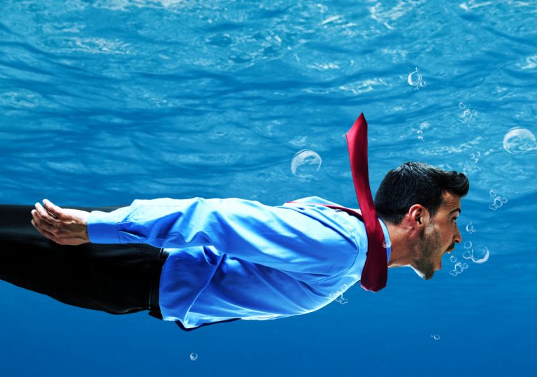 shutterstock_161237492 Funny businessman swimming underwater