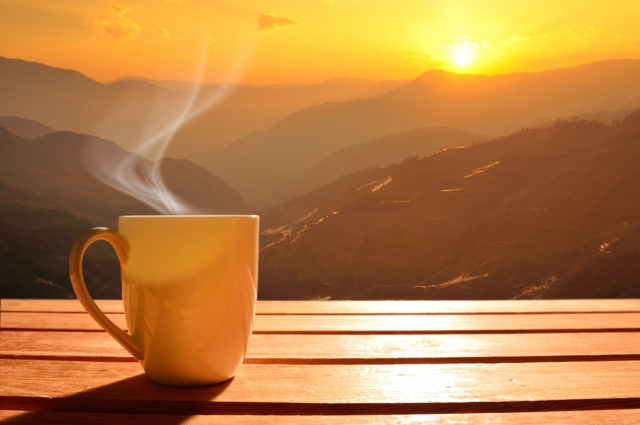 shutterstock_264132746 Morning cup of coffee with mountain background at sunrise