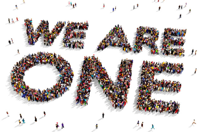 shutterstock_301844315 Large group of people seen from above gathered together to form the text 