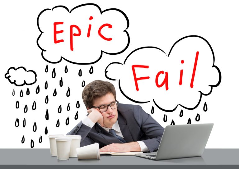 shutterstock_366448784 businessman sleeping at working place with his head on hand, open laptop in front of him, several glasses of coffee to the left, words 'epic fail' over his head. Concept of failure.