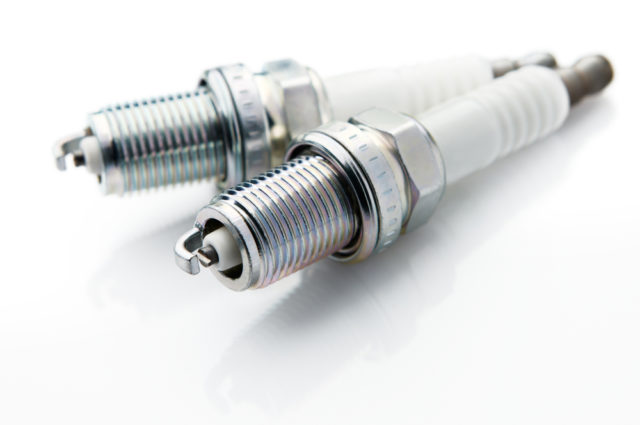 shutterstock_53242528 spark plugs on white background, shallow depth of field
