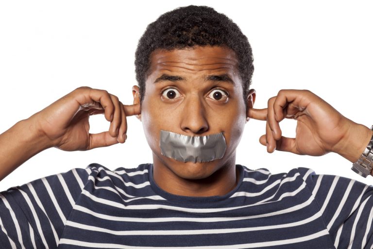 shutterstock_221215255 Young African man with closed ears and adhesive tape over his mouth