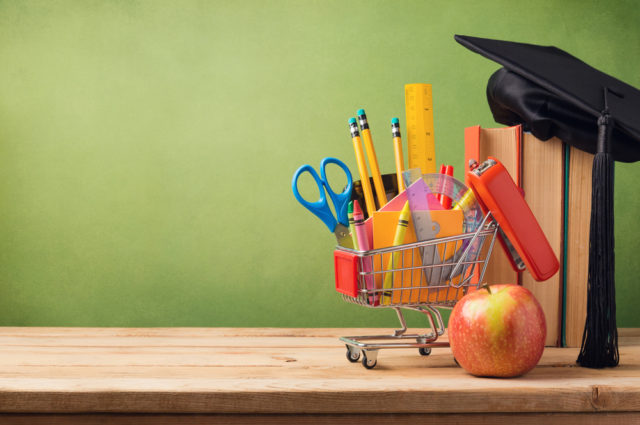 shutterstock_298836944 Back to school concept with shopping cart, books and graduation hat