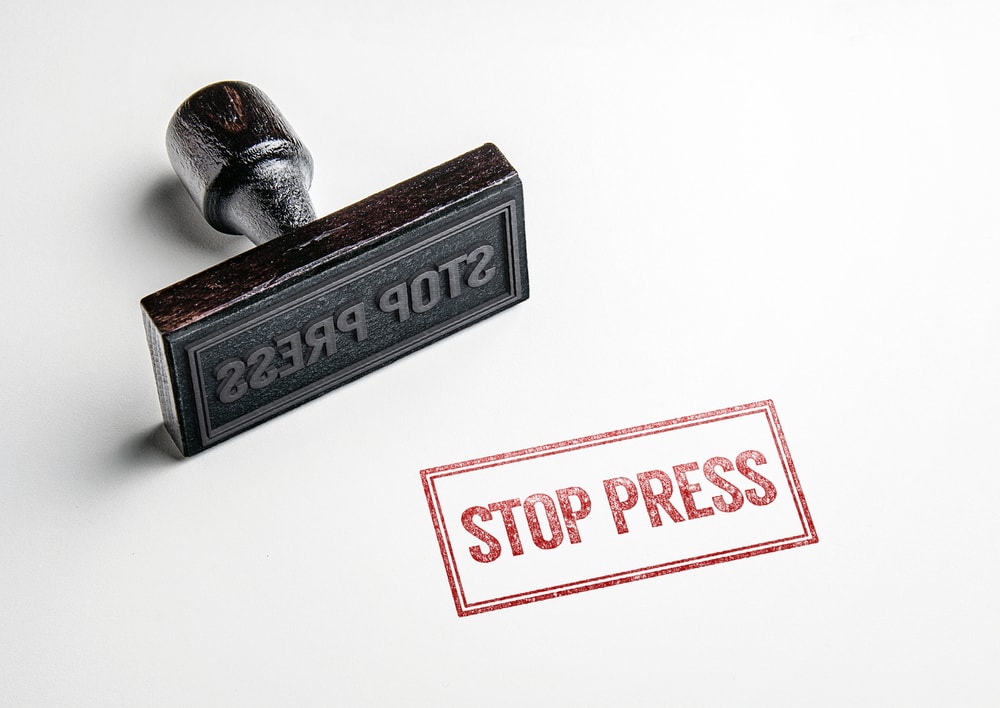 shutterstock_430725784 Rubber stamping that says 'Stop Press'.