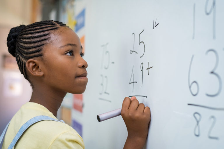 Portrait Of African Girl Writing Solution Of Sums
