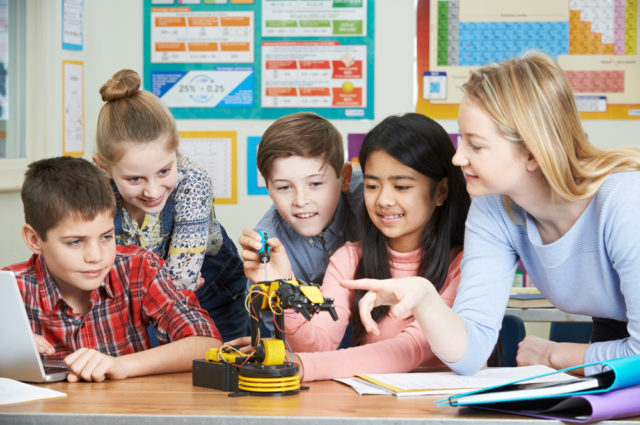 By SpeedKingz Royalty-free stock photo ID: 603105296 Pupils And Teacher In Science Lesson Studying Robotics