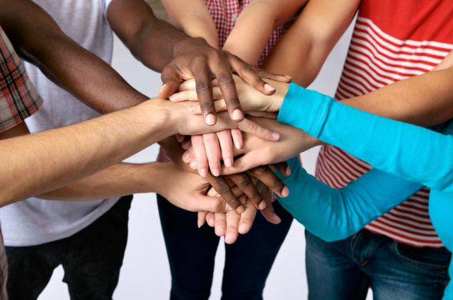 Team of Friends Showing Unity With Their Hands Together
