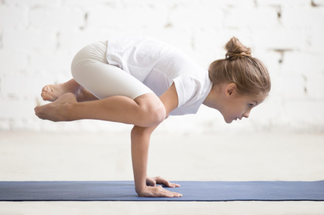 Side View Of Girl Child Practicing Yoga