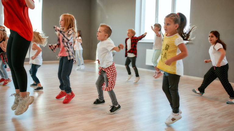 Group,of,little,boys,and,girls,dancing,while,having,choreography