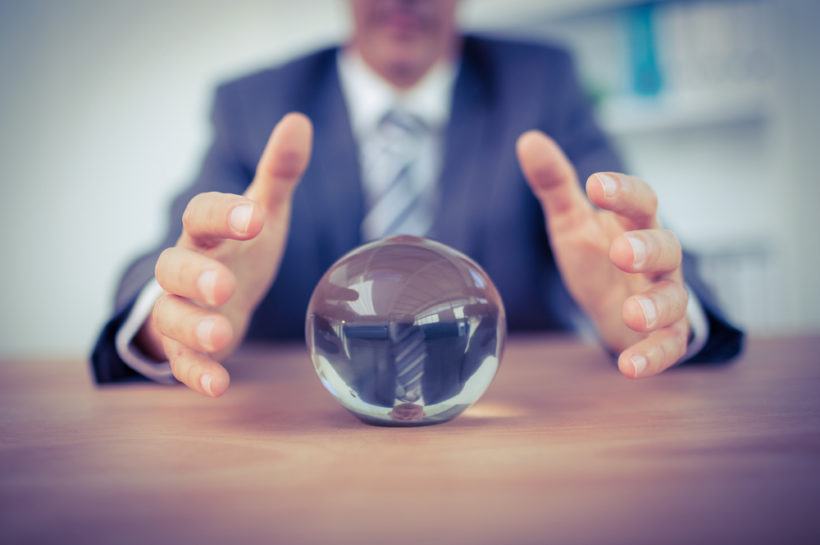 Businessman,forecasting,a,crystal,ball,in,the,office