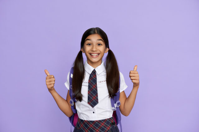 Excited,indian,kid,primary,school,girl,with,backpack,wearing,uniform