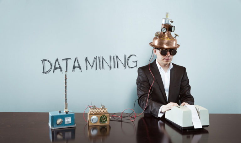 Data,mining,concept,with,vintage,businessman,and,calculator,at,office