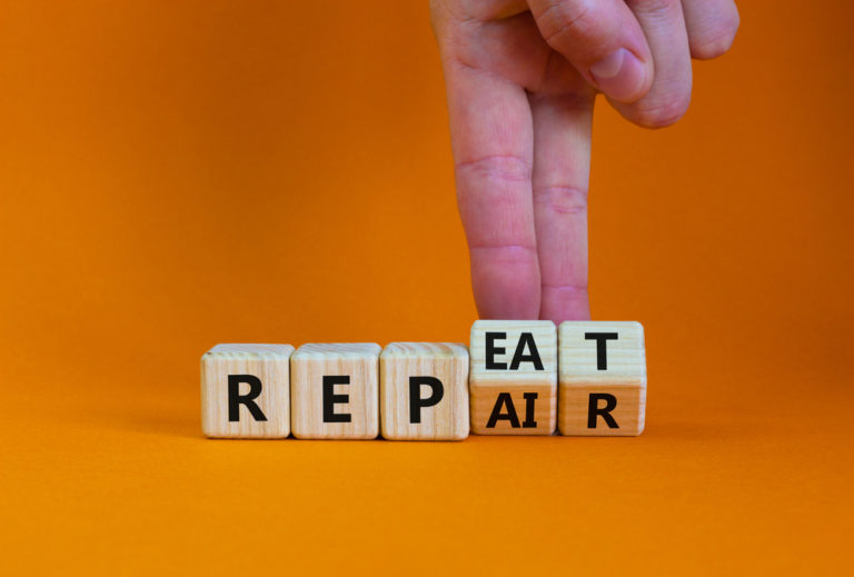 Repeat,and,repair,symbol.,businessman,turns,wooden,cubes,and,changes