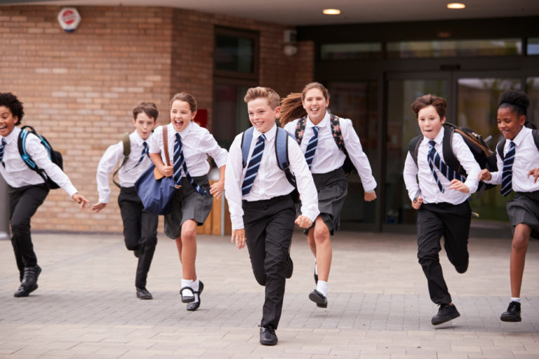 Group,of,high,school,students,wearing,uniform,running,out,of