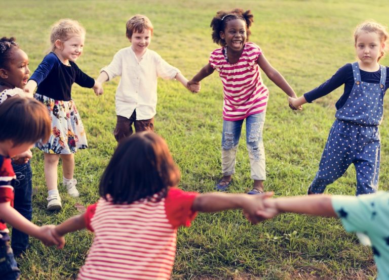 Diversity,group,of,kids,holding,hands,in,circle