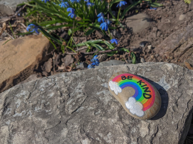 Sign,be,kind,and,a,rainbow,on,a,painted,rock.