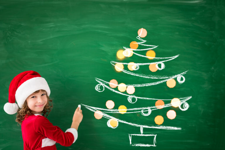 Happy,child,wearing,santa,claus,draws,on,green,blackboard.,christmas
